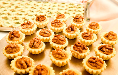 Display of assorted gluten free cupcakes with walnuts  sitting on display table