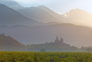 Scenic view of historic Gremi fortress at sunrise on background of mountains in Kakheti region, Georgia.