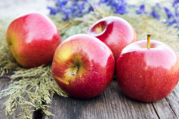 Ripe red apples on a wooden table. Vitamins and a healthy diet. Vegetarian concept.