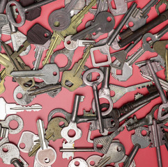 Keys set on pink background. Door lock keys and safes for proper