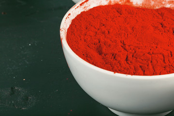 Indian Holi festival colours in small  bowls on dark background