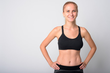 Fototapeta na wymiar Portrait of happy young blonde woman smiling ready for gym