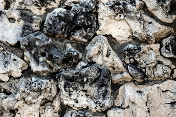 Natural porous stone background. Black and white stones texture.