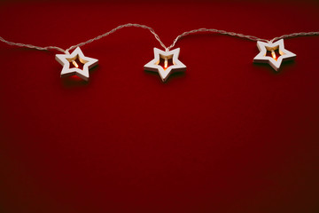 Illuminated star shaped garland on color background close up