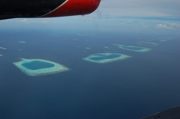 Naklejka na ściany i meble Flying over magnificent atolls of the Maldives
