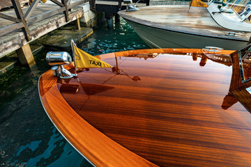 Venice, close up of two wooden water taxis moored in a canal, Canal grande, of the Venetian lagoon, the fastest way to travel in this city. Italy, Veneto, Europe