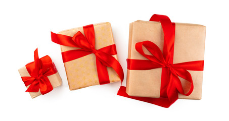Craft christmas gifts with red bows isolated on white background, top view