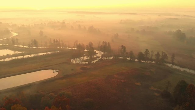 Drone aerial footage of hazy riverbed and meadows near river.Nida River valley in Poland early morning view. 