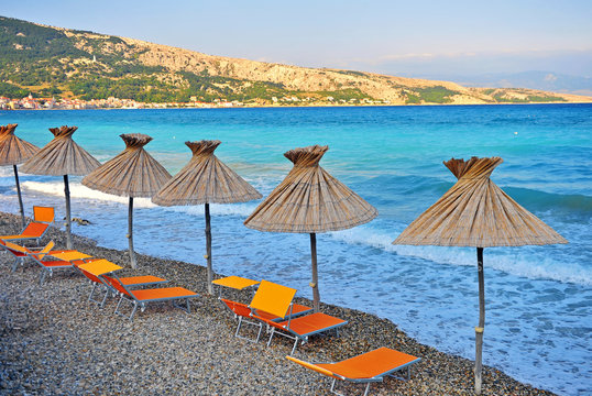 Empty pobbles beach of Krk island on sunset