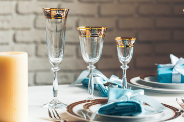 Close up shot of table setting for fine dining with cutlery and glassware
