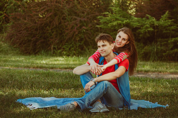 Beautiful young couple in love decided to have a romantic picnic in the park. A date, time spent together is priceless. Camping in the countryside.