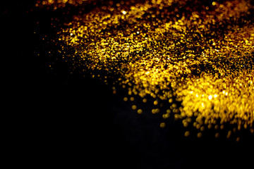 golden glitter sparkle isolated on black background