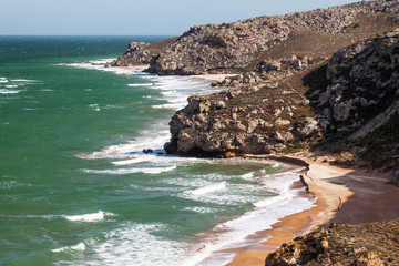 Sea of Azov. Sea waves are breaking on coastal cliffs.