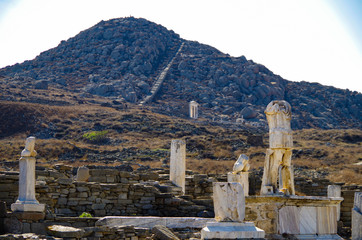 Ancient and historic temple ruins with columns and walls on archeologic site museum island Delos...