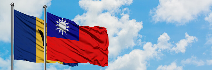 Barbados and Taiwan flag waving in the wind against white cloudy blue sky together. Diplomacy concept, international relations.