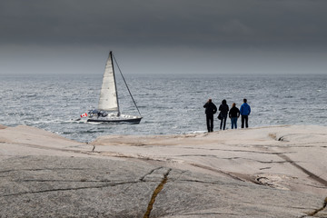 Sailboat sailing past rocks at Peggy's Cove © Lynda