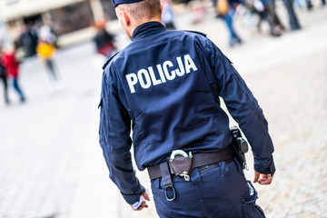 Wroclaw, Poland-ocobert/19/2019 The policeman on the street on duty. Close up of police logo.