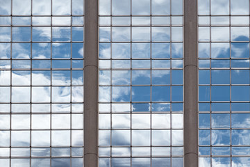 clouds reflecting on a glass building
