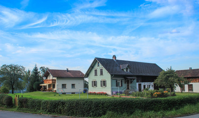Fototapeta na wymiar Beautiful cozy European houses surrounded by a garden in Liechtenstein.