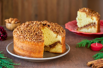 Almond cinnamon cake on wooden table. Close up	