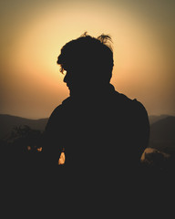 silhouette of man in sunset