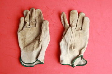 used leather work gloves in color background