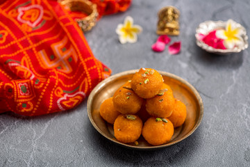Fototapeta na wymiar Motichoor Ladoo or Laddu - made from fine bundi, ball shaped sweets popular in indian subcontinent cooked with sugar, ghee or oil