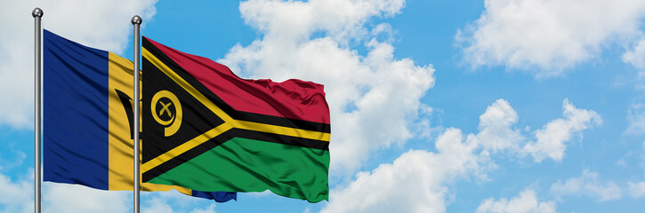 Barbados and Vanuatu flag waving in the wind against white cloudy blue sky together. Diplomacy...