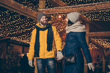 Photo of two people guy lady walking lights gifts market newyear evening enjoy snowy weather buying...