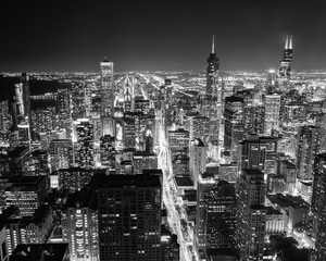 Filtered black and white image aerial view illuminated skyscrapers in downtown Chicago at dusk - 297574670