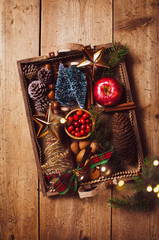 Variety of Christmas and New year decorations  in wood tray over rustic background.  Flat lay, space.