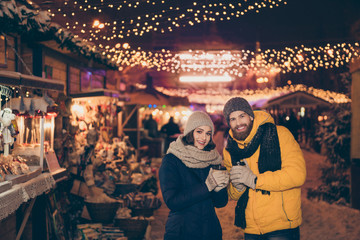 Photo of two people couple with hot tea beverage in hands celebrating x-mas eve night spend time...