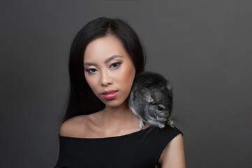 Asian woman holds grey chinchilla