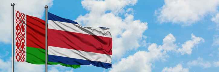 Fototapeta na wymiar Belarus and Costa Rica flag waving in the wind against white cloudy blue sky together. Diplomacy concept, international relations.