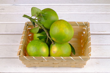 Oranges in a basket  on white table