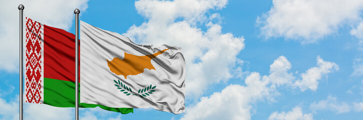Fototapeta na wymiar Belarus and Cyprus flag waving in the wind against white cloudy blue sky together. Diplomacy concept, international relations.