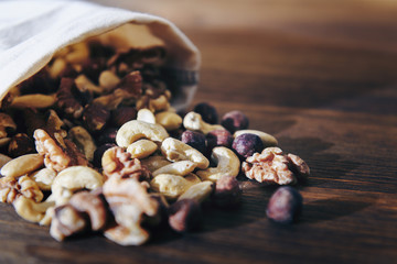 mix of nuts and dry fruits in wooden table