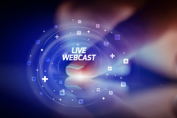 Finger touching tablet with social media icons and LIVE WEBCAST