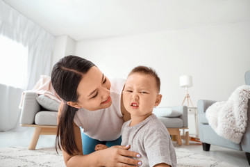 Happy Asian mother and cute little baby at home