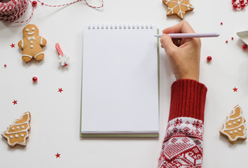 Goal lift for New Year. Holiday decorations and notebook with clean note book on white table, flat...