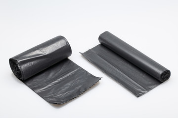 Roll of black dustbin liners isolated on a white background