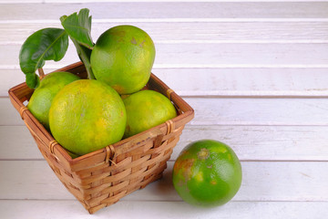 Oranges in a basket  on white table