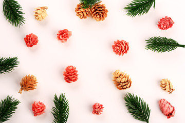 New Year's layout. Fir branches. Multi-colored cones. Top view. White background.