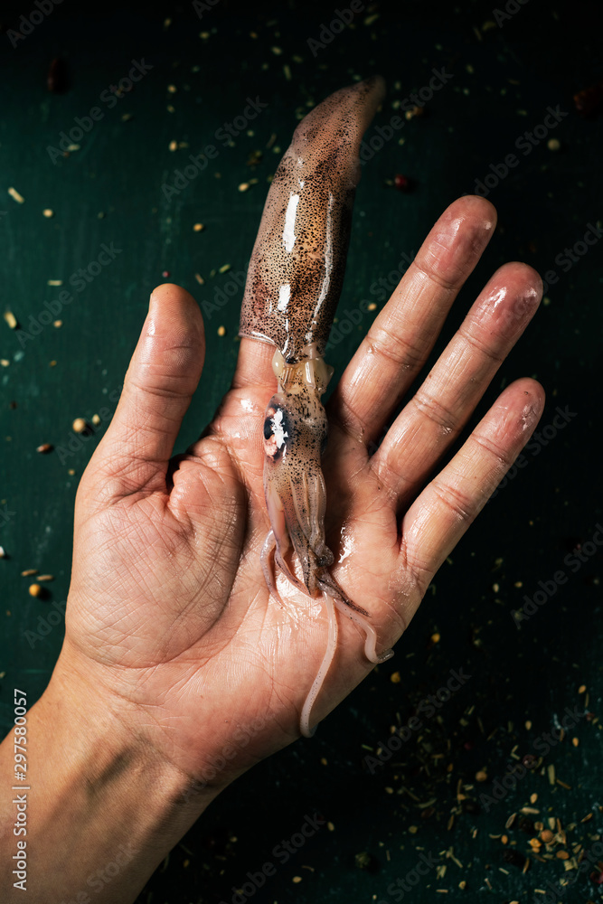 Poster man with a raw squid in his finger