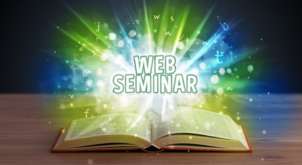 WEB SEMINAR inscription coming out from an open book, educational concept