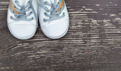 Baby boy cute shoes on wooden background