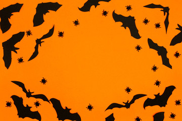 Flat lay halloween composition on orange background.