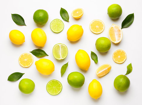 Ripe lemons and limes on white background