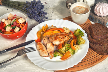 Fried chicken breast with vegetables on the table