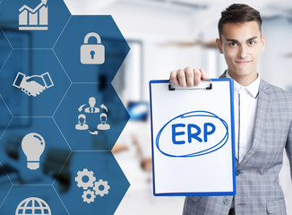 Business, technology, internet and network concept. Young businessman shows a keyword: ERP